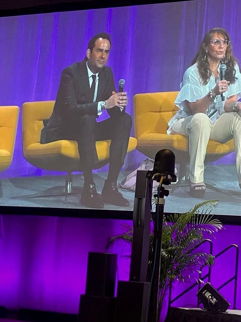 Panel discussion with two speakers on stage.