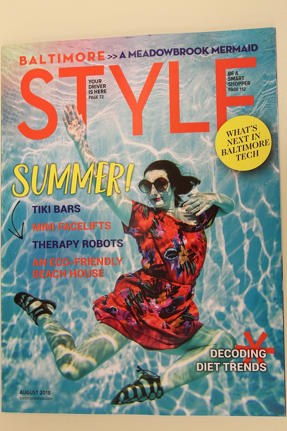 Colorful magazine cover featuring a woman swimming.
