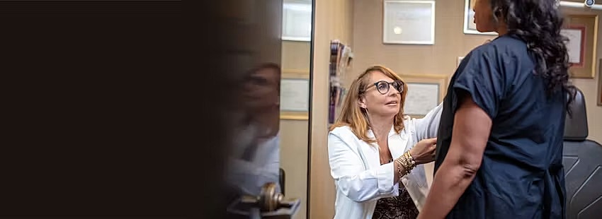 Doctor examining a patient in a clinical setting.