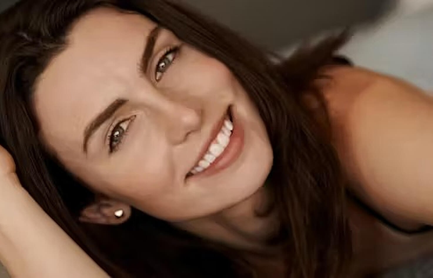 Two women smiling in professional attire.