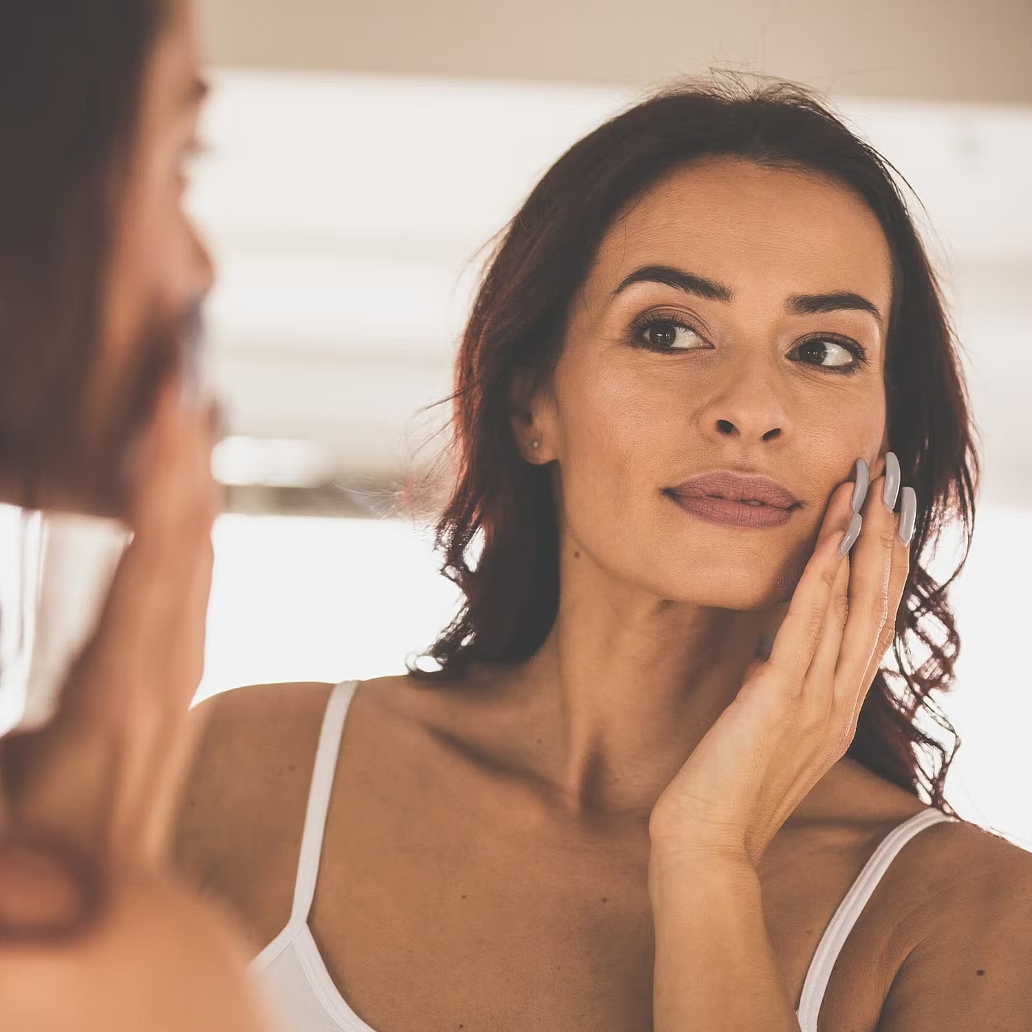 Model in brown swimwear posing confidently.