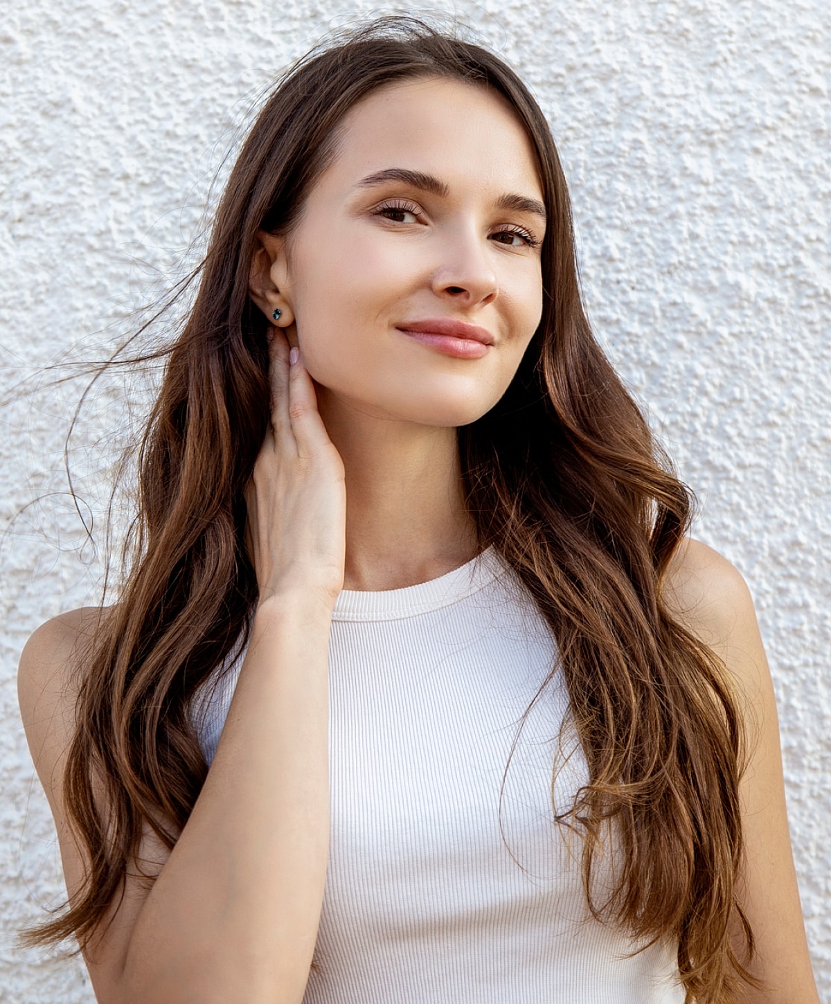 Young woman with long hair posing confidently.