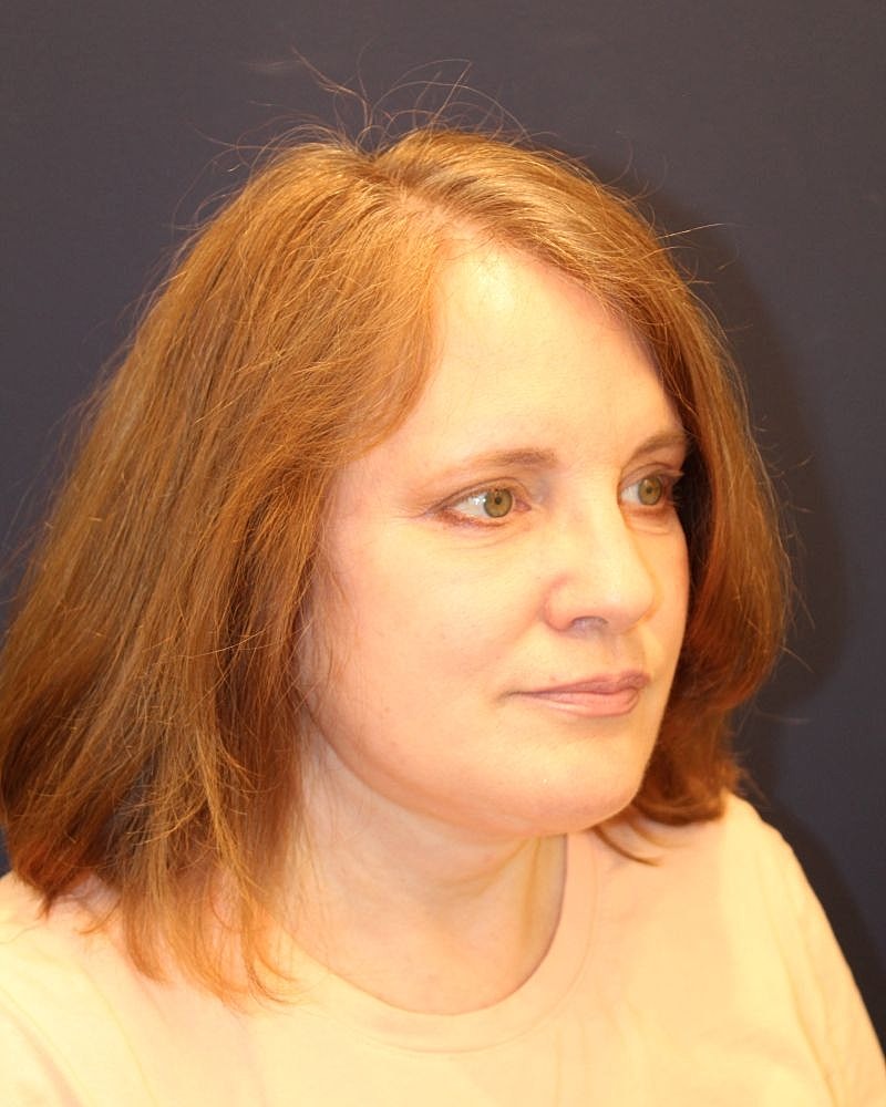 Woman with light brown hair and green eyes.