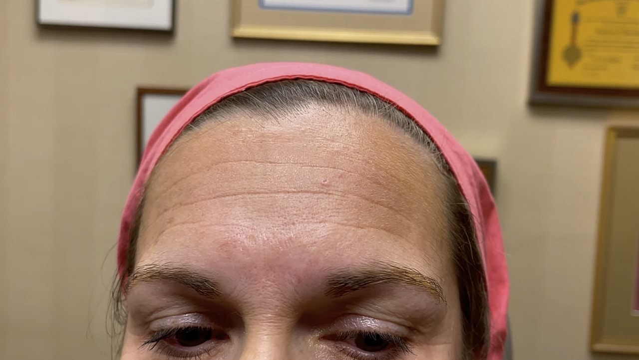 Person looking up with a pink headband.