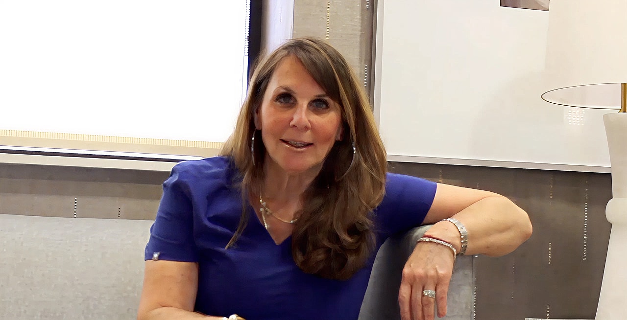 Woman sitting, explaining something in an interview.